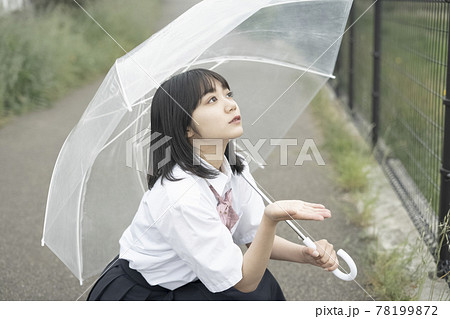 通学路で傘をさす女子高生の写真素材 [78199872] - PIXTA