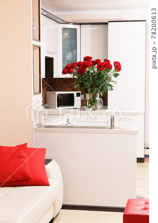 Woman takes dead dry bouquet of roses flowers out of vase. Housewife taking care of coziness on kitchen. 78200613
