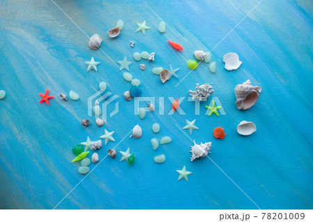 Seashells summer background. Many different seashells, starfish on a background of turquoise paint strokes. Place for text. 78201009