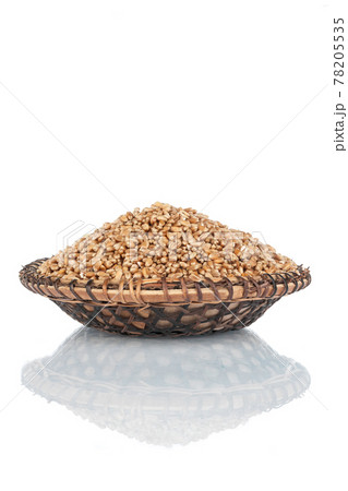 Heap of wheat grains in a wooden plate. Isolated Heap of wheat grains in a wooden plate. Isolated 78205535