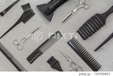 Full frame with hairdressing tools, combs, scissors on a gray background. Hair salon accessories, top view 78206803