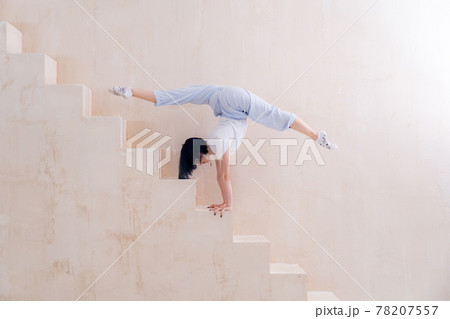 Flexible girl doing stretching and handstand in studio. Concept of individuality, creativity and self-confidence 78207557