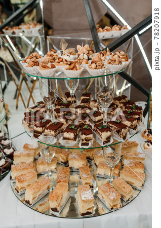 Sweet cakes at a wedding banquet. Catering, sweet festive buffet. Candy bar Sweet cakes at a wedding banquet. Catering, sweet festive buffet. Candy bar 78207918