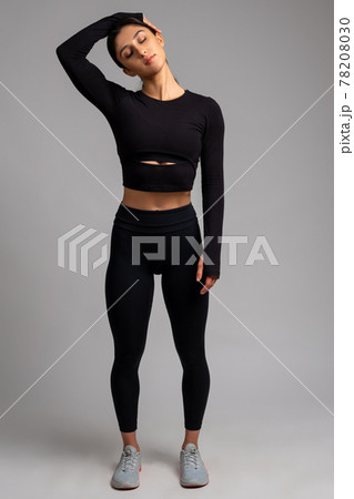 Female stretching before training on grey background 78208030
