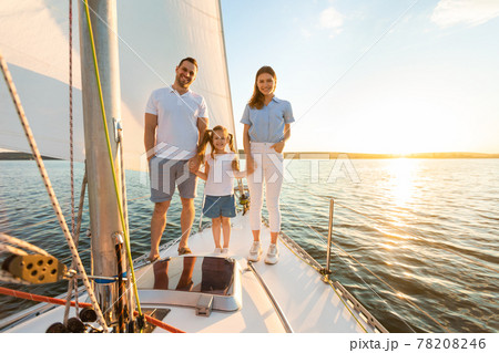 Family Standing On Boat Deck Sailing On Yacht In Sea Family Standing On Boat Deck Sailing On Yacht In Sea 78208246