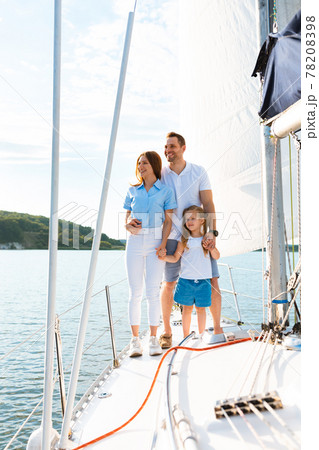 Cheerful Family Of Three Sailing On Yacht In Sea, Vertical 78208398