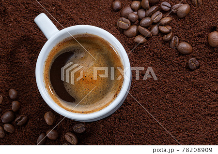Cup of coffee on coffee background Cup of coffee on coffee background 78208909