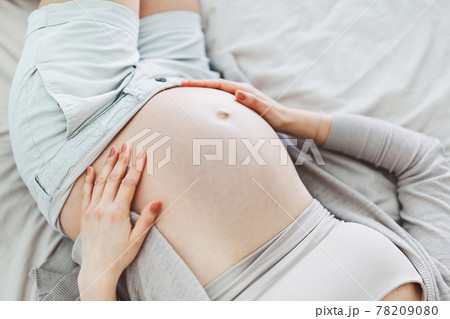 Pregnant woman lying on bed. Pregnant woman lying on bed. 78209080