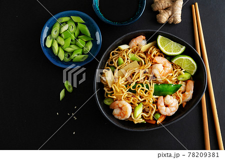 Asian noodles on plate on dark background Asian noodles on plate on dark background 78209381