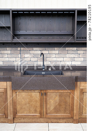 Comfortable summer kitchen with ash furniture and new sink 78210195