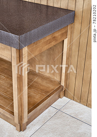Furniture of toned ash timber in cookhouse on open terrace 78210202