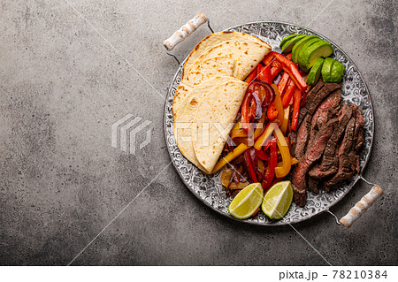 Mexican dish Beef fajitas with tortillas from above copy space Mexican dish Beef fajitas with tortillas from above copy space 78210384