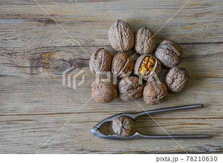 Walnuts closeup on a wooden background, selective focus 78210630