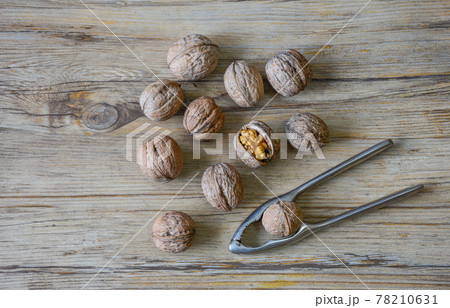 Walnuts closeup on a wooden background, selective focus Walnuts closeup on a wooden background, selective focus 78210631