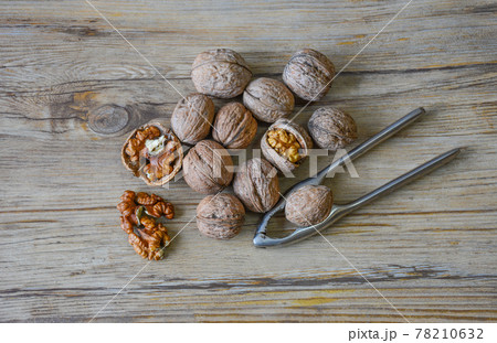 Walnuts closeup on a wooden background, selective focus 78210632