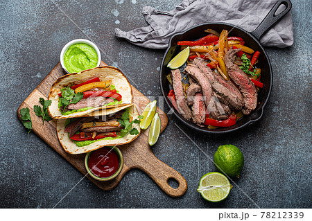 Making mexican dish fajitas tacos from above 78212339