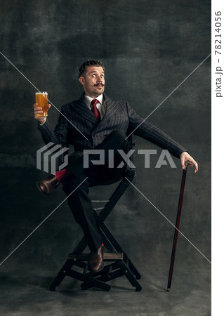 Young man in art action remaking greatest paintings on dark background. Retro style, comparison of eras concept. 78214056