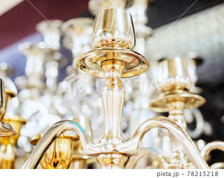Fragment of golden shiny candelabrum on blurred background 78215218