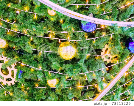 Background texture Christmas tree decorated with garlands and golden and blue balls. Background texture Christmas tree decorated with garlands and golden and blue balls. 78215229