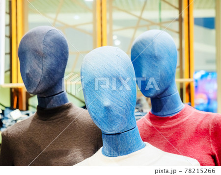 Mannequins with denim faces in colored turtlenecks in a store. Focus to the foreground Mannequins with denim faces in colored turtlenecks in a store. Focus to the foreground 78215266