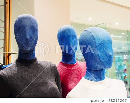 Mannequins covered in denim in colored turtlenecks in a store. 78215267