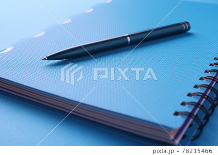 Black pen lies on blue notebook with documents Black pen lies on blue notebook with documents 78215466