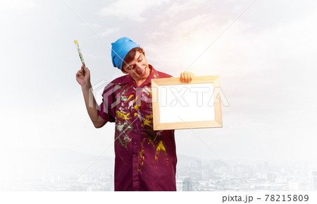 Young handsome painter artist holding paintbrush 78215809