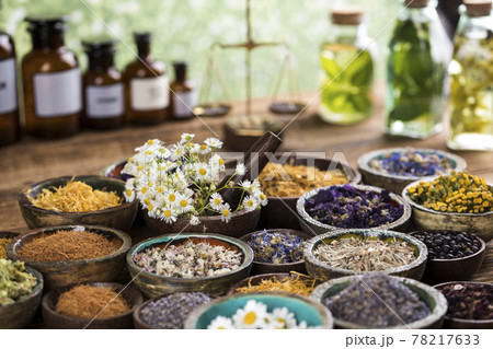 Natural remedy and wooden table background Natural remedy and wooden table background 78217633