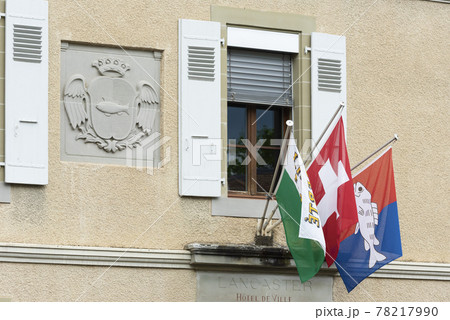 coast of arms and flags on a facade in Nyon, switzerland coast of arms and flags on a facade in Nyon, switzerland 78217990