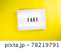Lightbox with text FAKE isolated on yellow background, fake emotions, person 78219791