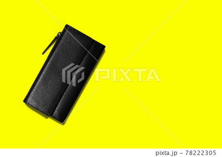 Fashionable leather women's wallet on a yellow background. added copy space for text. 78222305