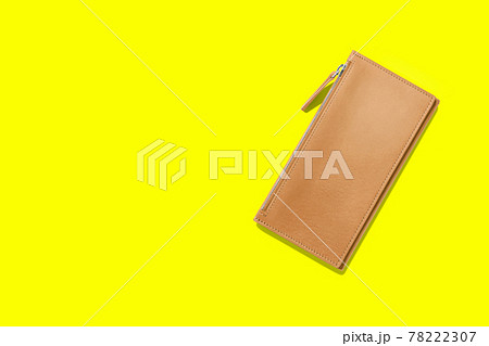 Fashionable leather women's wallet on a yellow background. added copy space for text. 78222307