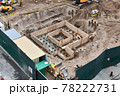 Excavators digging on skyscraper construction site with foundation pit 78222731