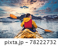 Woman paddle a canoe on an icy bay in Alaska exploring glaciers 78222732