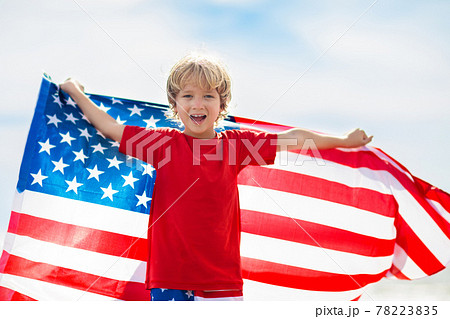 Kids with American flag on beach. 4th of July. Kids with American flag on beach. 4th of July. 78223835