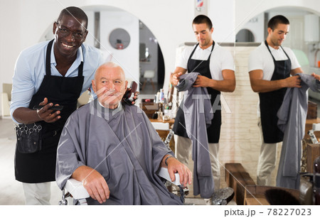 African hairdresser discussing haircut with elderly man African hairdresser discussing haircut with elderly man 78227023
