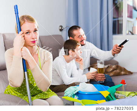Upset woman with cleaning equipment 78227035