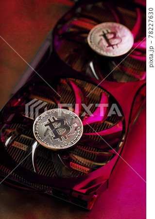 Bitcoin on a graphic card with a Pink neon light on a dark background. 78227630