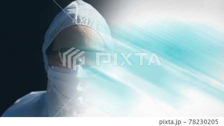 Composition of person wearing ppe suit and mask, with blurred blue copy space Composition of person wearing ppe suit and mask, with blurred blue copy space 78230205