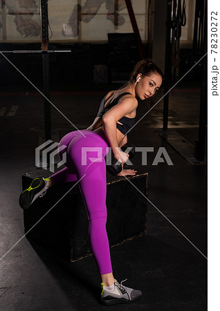 Young beautiful woman doing one-arm dumbbell back exercise on bench. Athletic girl in the gym. Exercises for the latissimus dorsi. 78230272