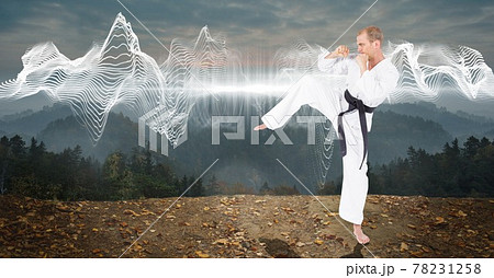 Composition of male martial karate artist with black belt practicing in mountains with copy space Composition of male martial karate artist with black belt practicing in mountains with copy space 78231258