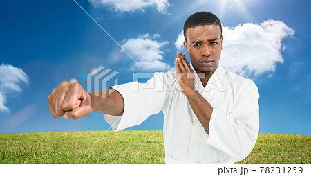 Composition of male martial karate artist practicing in countryside with copy space 78231259