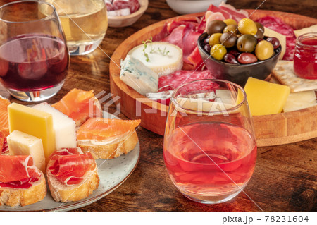 Wine, sandwiches, charcuterie and cheese board on a rustic wooden background Wine, sandwiches, charcuterie and cheese board on a rustic wooden background 78231604