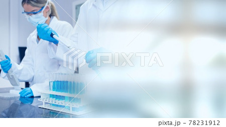 Composition of male and female lab technicians at work, with blurred copy space to right 78231912