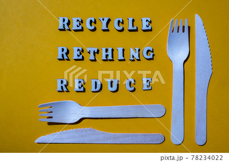 RECYCLE RETHING REDUCE text Wooden forks and paper cups with plates on color background. Eco friendly disposable tableware. Used in fast food, restaurants, takeaways, picnics. No plastic 78234022