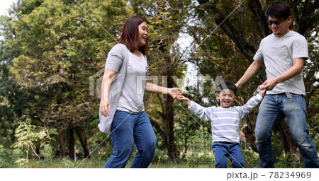 Happy Asian family dancing in the garden public park, Feeling happiness of holiday weekend concept Happy Asian family dancing in the garden public park, Feeling happiness of holiday weekend concept 78234969