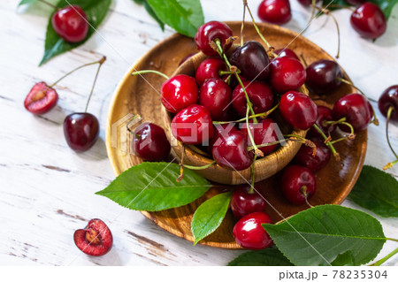 Ripe juicy berry cherry in a bowl on a kitchen rustic table. Ripe juicy berry cherry in a bowl on a kitchen rustic table. 78235304