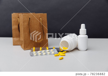Online shoppng concept. Bags with compounded prescription medications shipped from a mail order pharmacy on a grey background Online shoppng concept. Bags with compounded prescription medications shipped from a mail order pharmacy on a grey background 78236882
