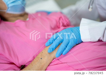 Asian doctor wearing PPE suit new normal to check patient with mask protect safety infection Covid-19 Coronavirus outbreak at quarantine nursing hospital ward. 78237045