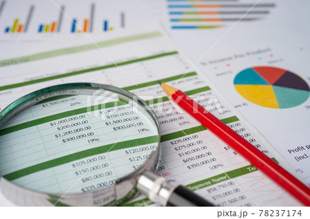 Magnifying glass with pencil on spreadsheet table and graph paper; Finance development, Banking Account, Statistics Investment Analytic research data economy, trading, Mobile office reporting Business 78237174